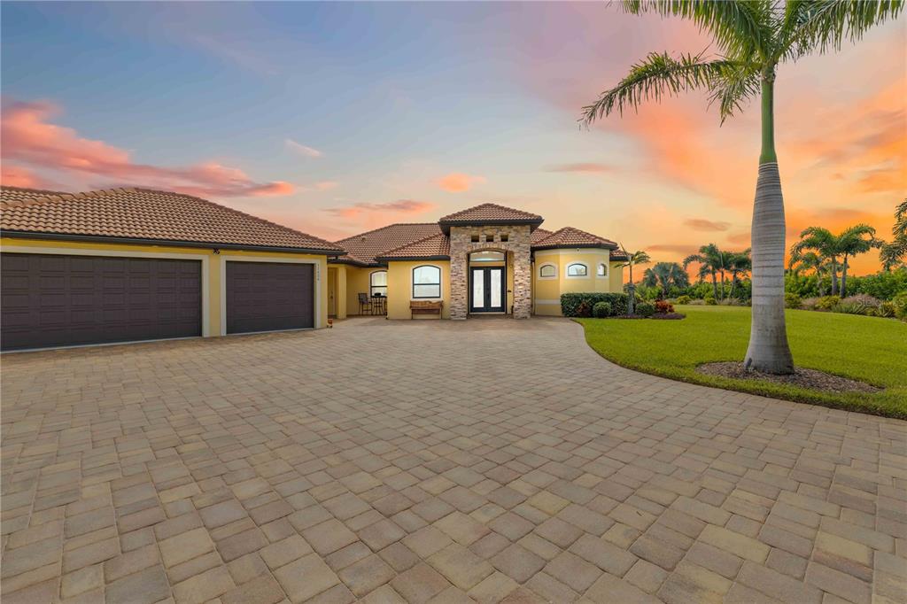 11626 Bridle Path Lane Placida, FL 33946 - Photo 2 of 51 front view of a house with a yard and palm trees