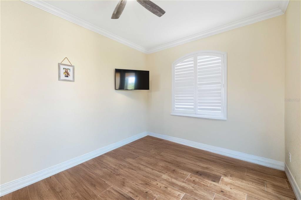 11626 Bridle Path Lane Placida, FL 33946 - Photo 32 of 51 wooden floor in an empty room with a window