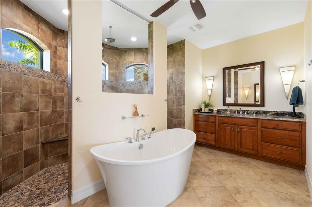 11626 Bridle Path Lane Placida, FL 33946 - Photo 34 of 51 a bathroom with a tub sink and mirror
