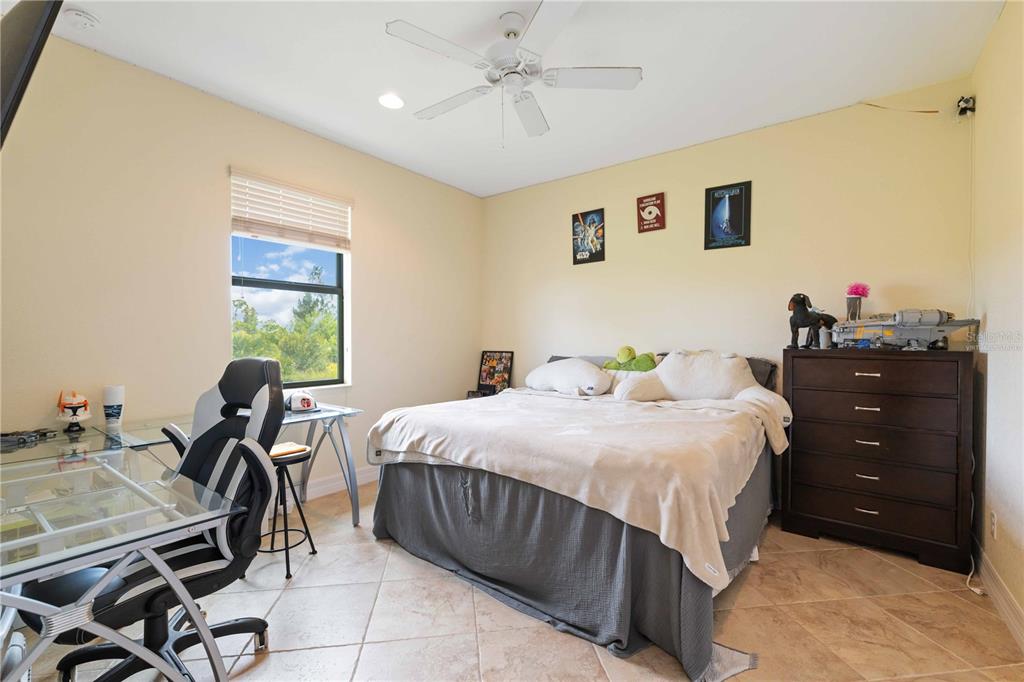 11626 Bridle Path Lane Placida, FL 33946 - Photo 5 of 51 a bedroom with a bed and a desk