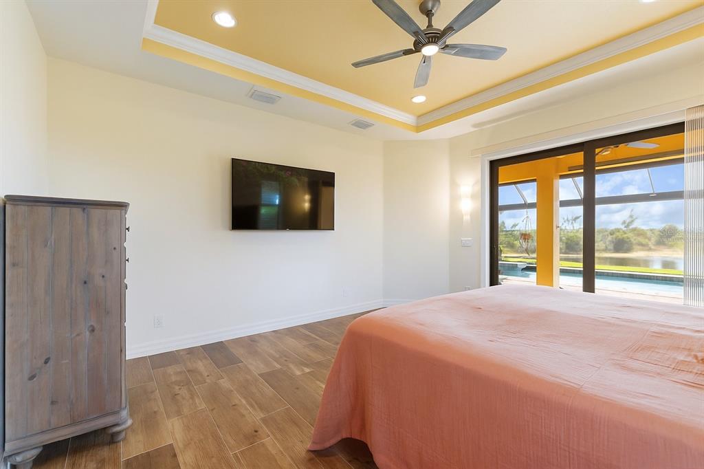 11626 Bridle Path Lane Placida, FL 33946 - Photo 6 of 51 a bedroom with a bed and a flat screen tv