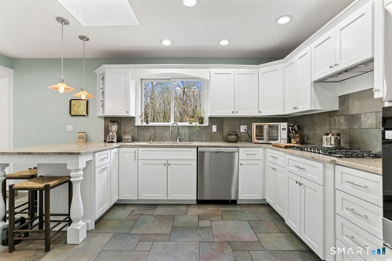 86 Seventy Acre Road Redding, CT 06896 - Photo 8 of 40 a kitchen with a sink window and cabinets