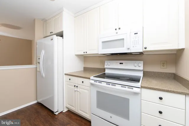 a kitchen with a stove microwave and refrigerator