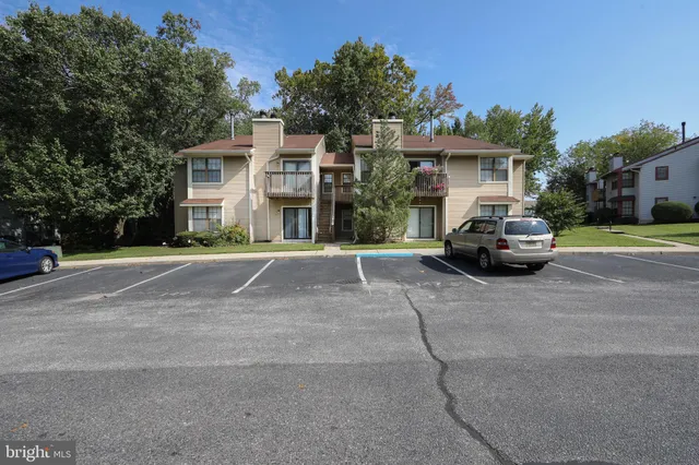 a car parked in front of a white house