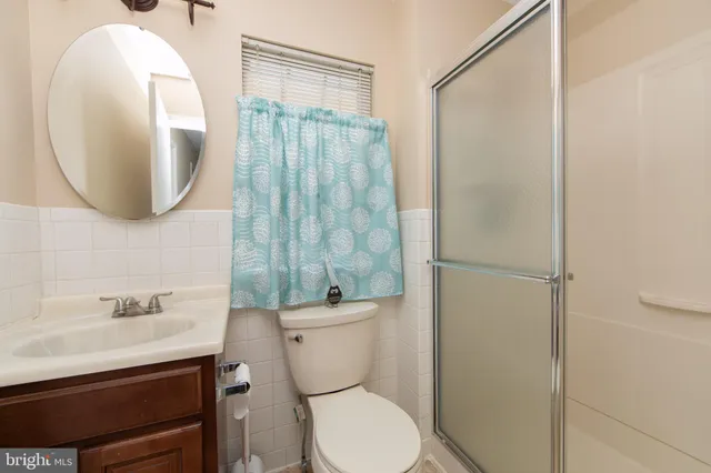 a bathroom with a toilet a sink and a mirror