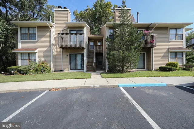 front view of a brick house with a yard