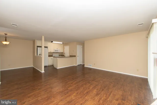 a view of a kitchen with wooden floor