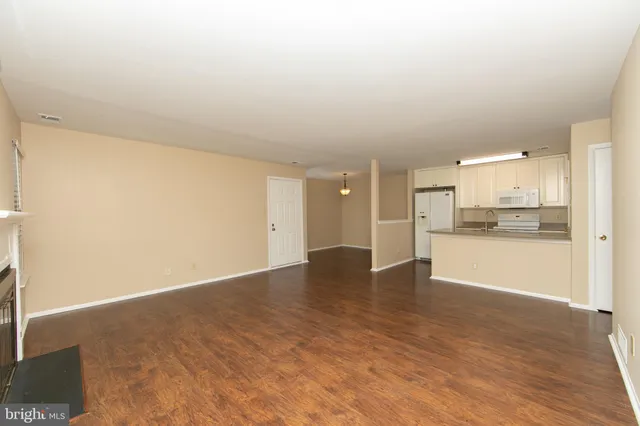 a view of kitchen with kitchen island wooden floor and window