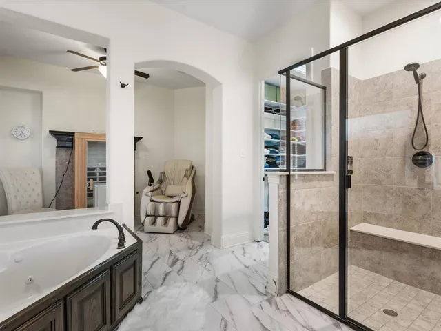 a bathroom with a double vanity sink a mirror and a bathtub