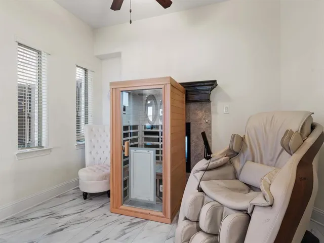 a bathroom with a granite countertop tub shower and mirror