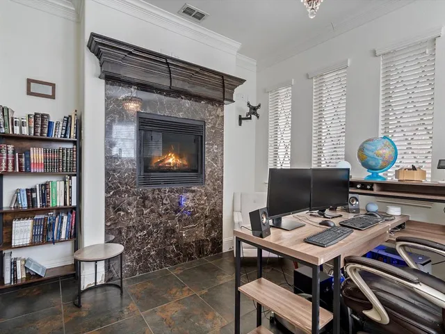 a living room with furniture and a bookshelf