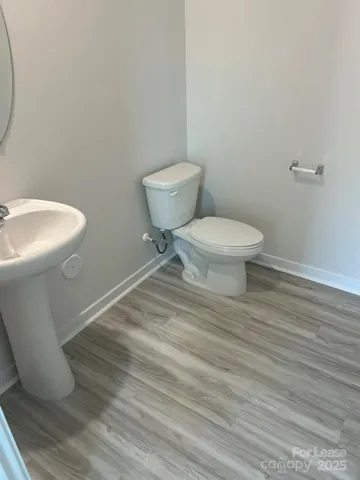 a white toilet sitting next to a white sink