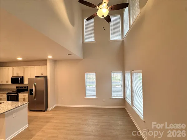 a view of a kitchen with an entryway and wooden floor
