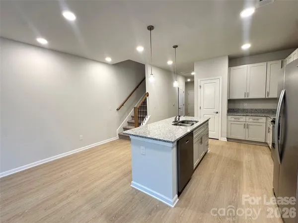 a large kitchen with a stove and a sink
