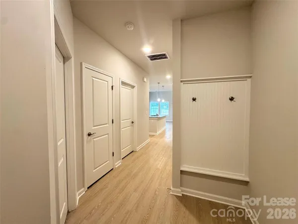 a view of a hallway with wooden floor