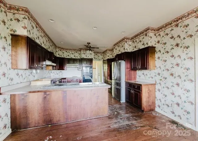 a kitchen with stainless steel appliances granite countertop a sink stove and oven