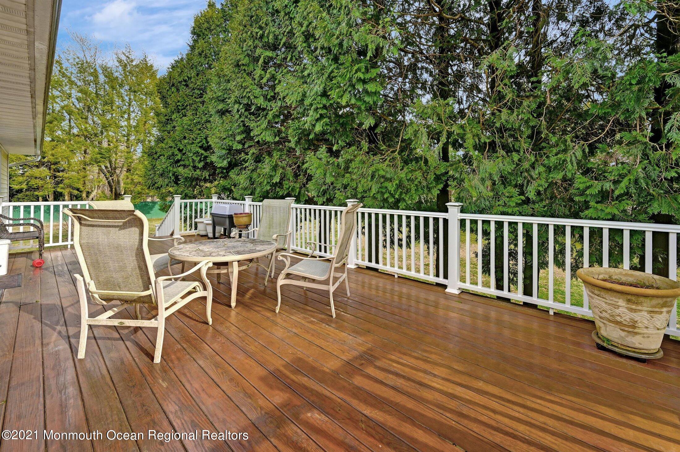 25 Clayton Road Howell, NJ 07731 - Photo 22 of 29 a view of a chairs and table on the wooden floor