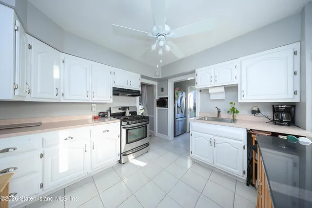 a kitchen with cabinets stainless steel appliances and a counter top space