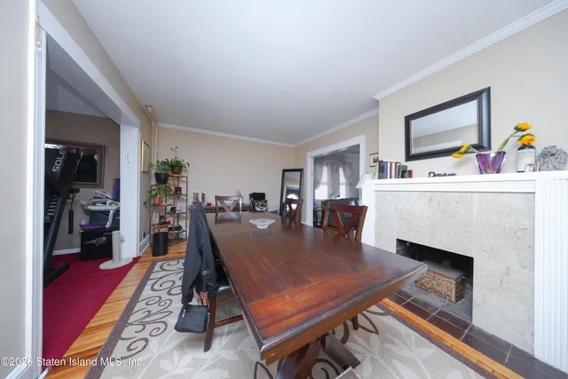 a dining room with furniture and wooden floor