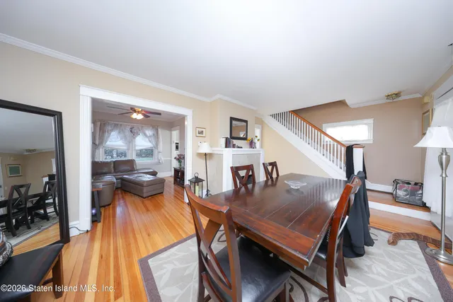 a dining room with furniture and wooden floor