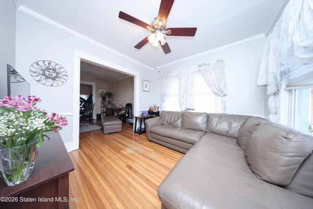 a living room with furniture and flowers