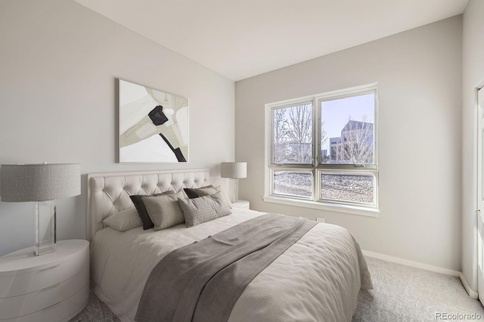 4875 South Monaco Street, Unit 103 Denver, CO 80237 - Photo 16 of 44 a bedroom with a bed and a painting on the wall