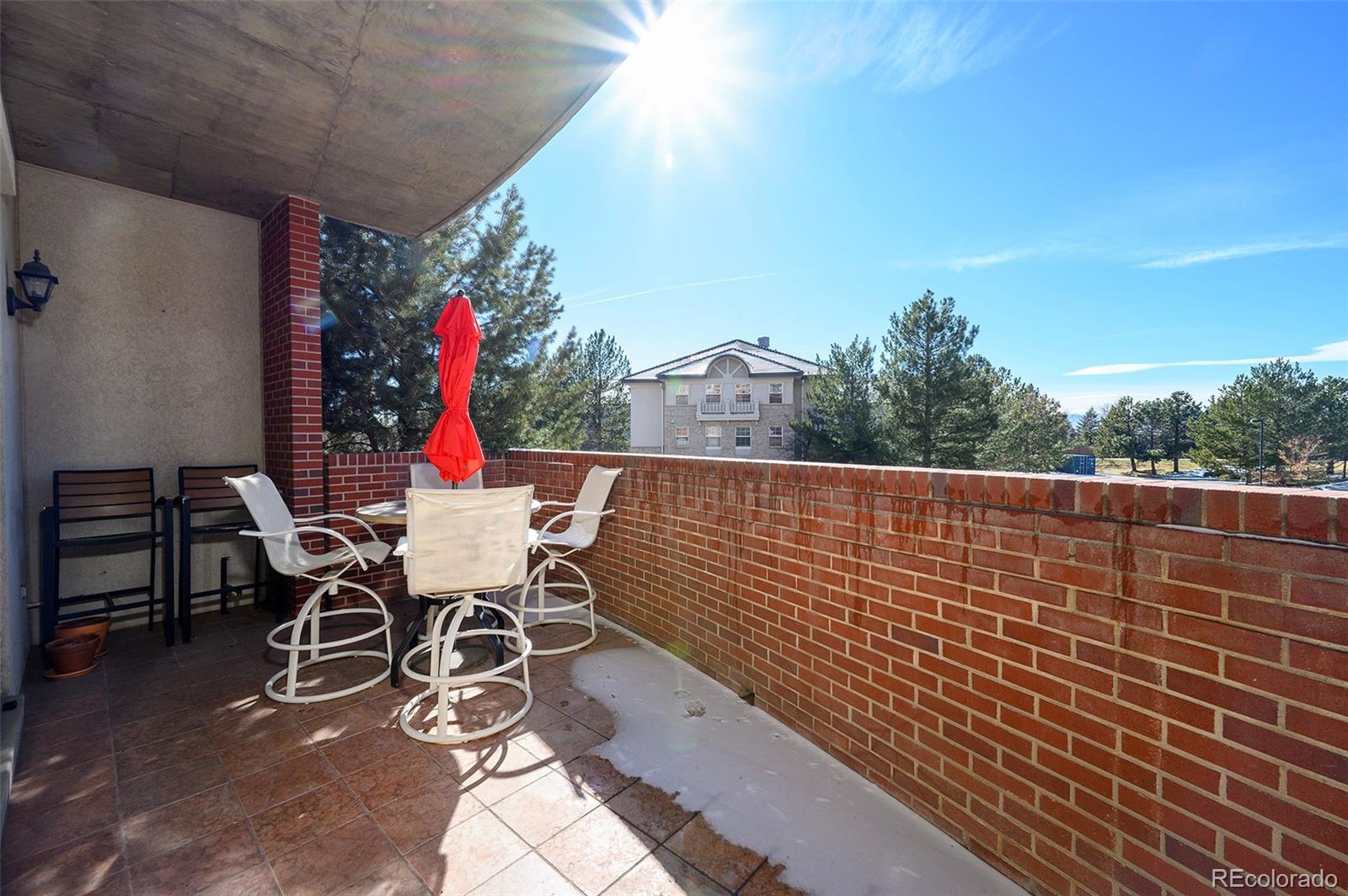 4875 South Monaco Street, Unit 103 Denver, CO 80237 - Photo 23 of 44 a roof deck with table and chairs and potted plants