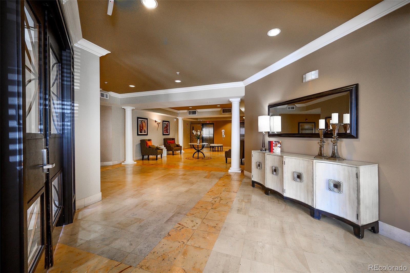 4875 South Monaco Street, Unit 103 Denver, CO 80237 - Photo 3 of 44 a living room with furniture and flat screen tv