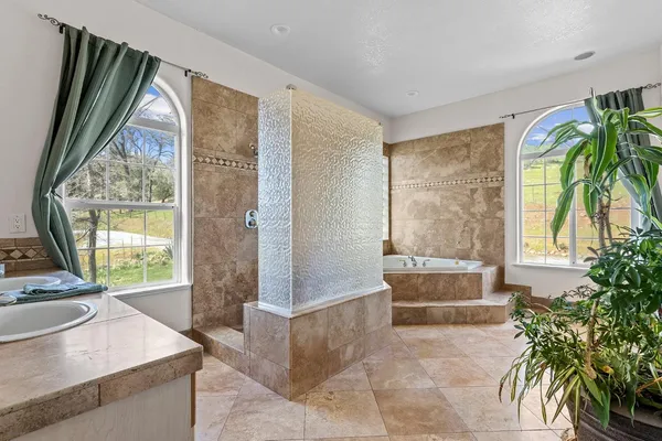 a bathroom with a glass shower door