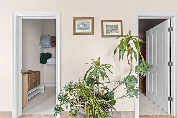 a living room with furniture kitchen view and large windows