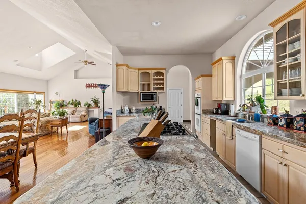 a bedroom with a large bed and a chandelier