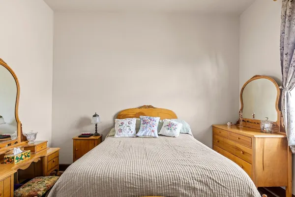a view of a hallway with wooden floor and stairs