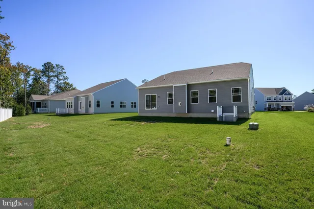 a front view of a house with a garden and deck