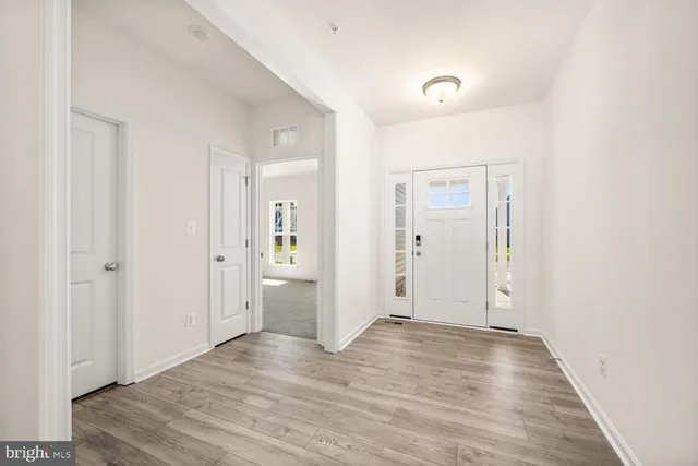 a view of a room with wooden floor and bathroom