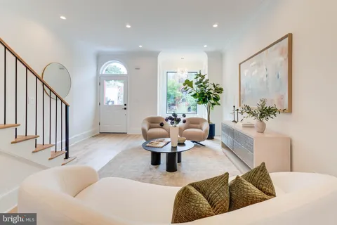 a living room with furniture and a large mirror