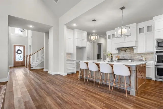 a large kitchen with a table and chairs