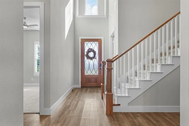 a view of entryway and hall with wooden floor