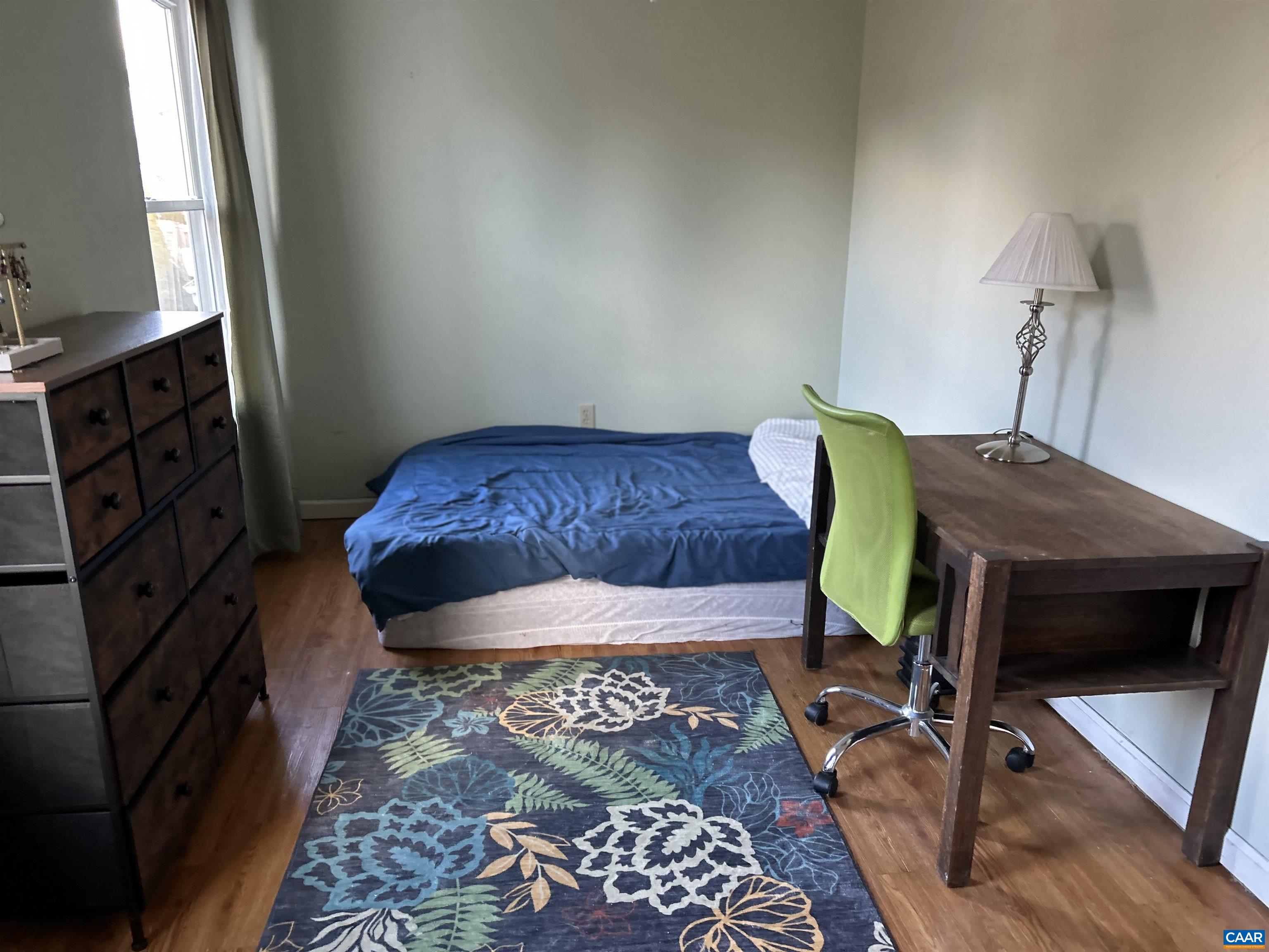 340 Riverside Avenue Charlottesville, VA 22902 - Photo 11 of 17 a bedroom with a bed and wooden floor