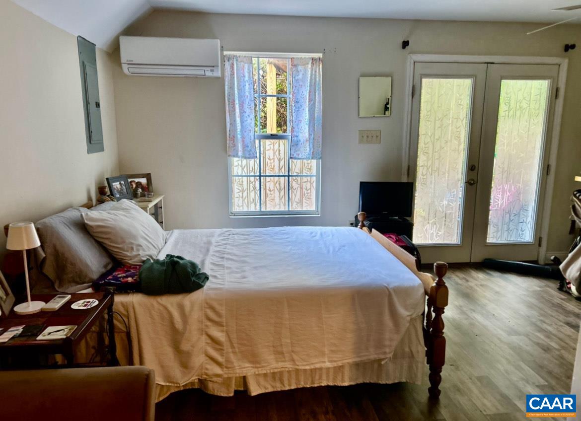 340 Riverside Avenue Charlottesville, VA 22902 - Photo 15 of 17 a bedroom with a bed and wooden floor