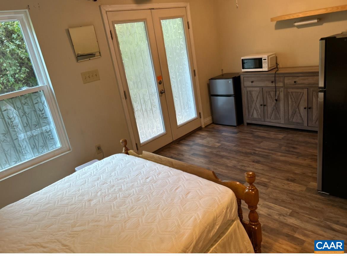 340 Riverside Avenue Charlottesville, VA 22902 - Photo 17 of 17 a bedroom with a bed and wooden floor