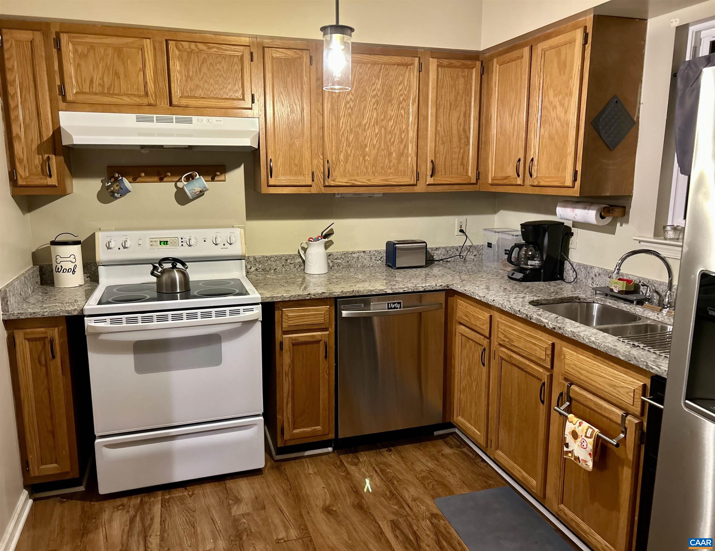 340 Riverside Avenue Charlottesville, VA 22902 - Photo 7 of 17 a kitchen with stainless steel appliances granite countertop a sink stove and cabinets