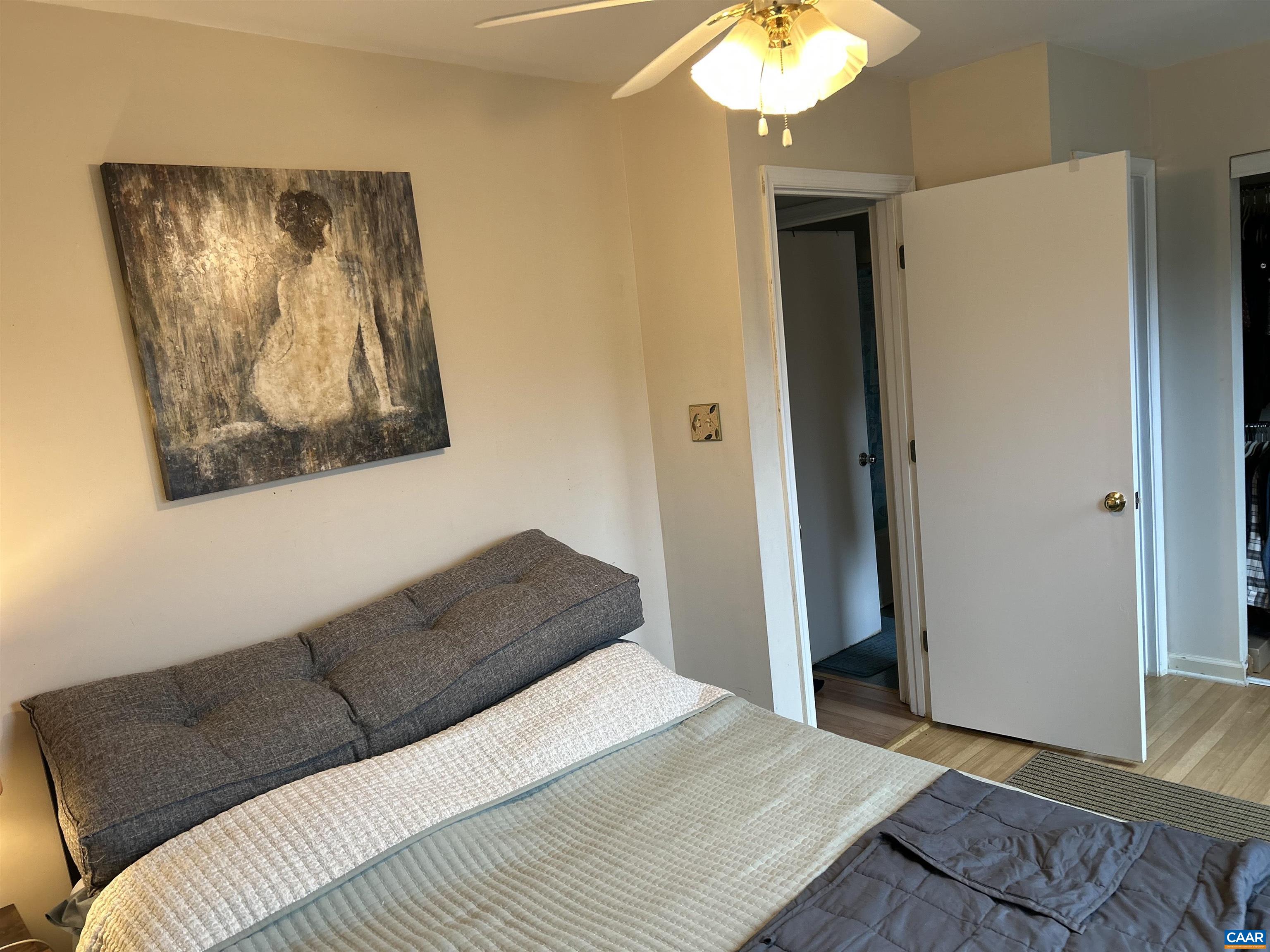 340 Riverside Avenue Charlottesville, VA 22902 - Photo 8 of 17 a bedroom with a bed and a chandelier