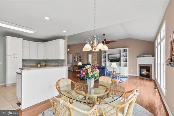 a kitchen with stainless steel appliances granite countertop a sink a stove a refrigerator a microwave and cabinets