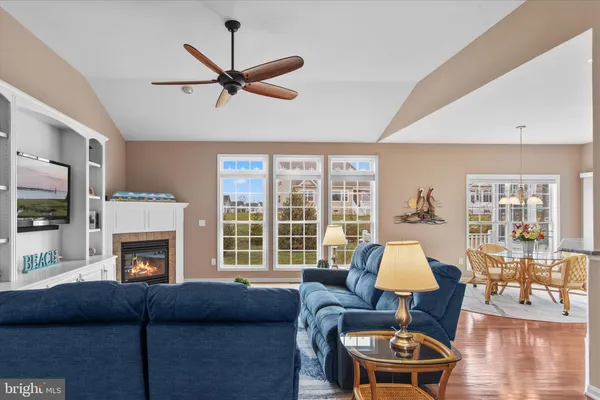 a dining room with furniture a fireplace and wooden floor