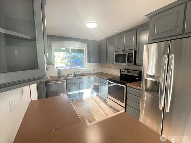 a kitchen with a refrigerator and a sink