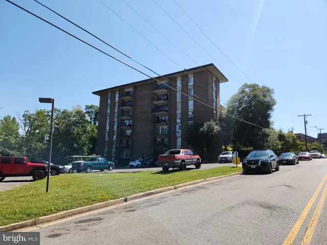 a car parked in front of a house and cars parked