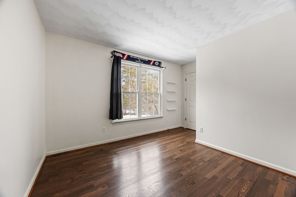 305 Raymond Road Plymouth, MA 02360 - Photo 16 of 29 an empty room with wooden floor and windows