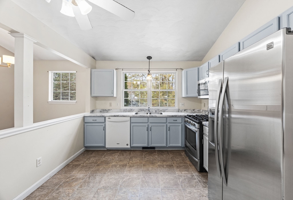 305 Raymond Road Plymouth, MA 02360 - Photo 7 of 29 a kitchen with granite countertop a center island stainless steel appliances cabinets and a large window