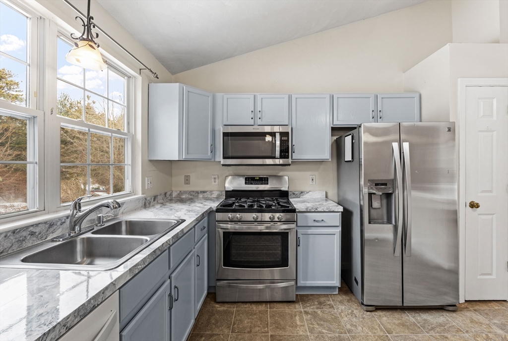 305 Raymond Road Plymouth, MA 02360 - Photo 8 of 29 a kitchen with a stove a sink and refrigerator