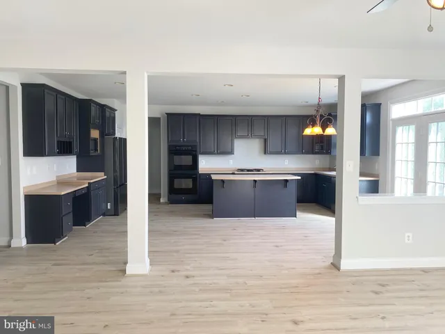 a large kitchen with stainless steel appliances and a sink